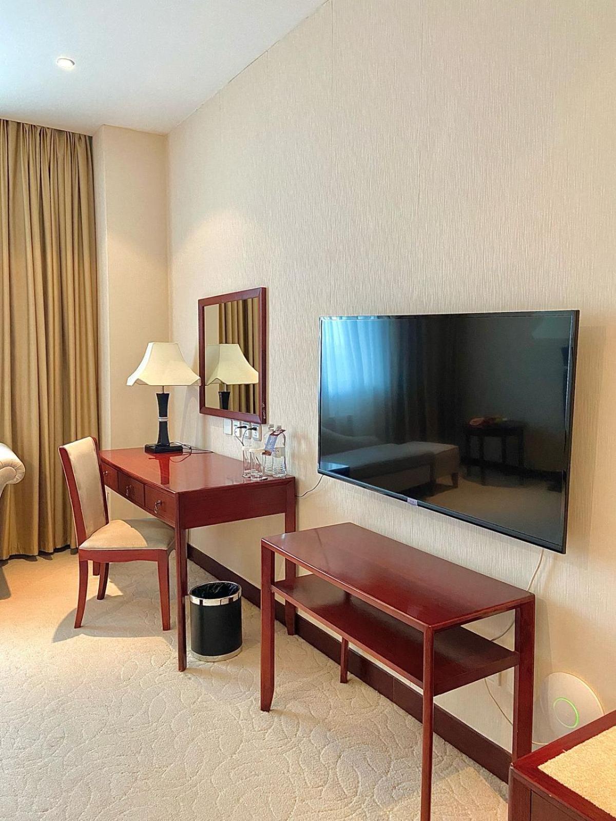 Beijing Palace Soluxe Hotel Astana Luaran gambar A television set in a hotel room